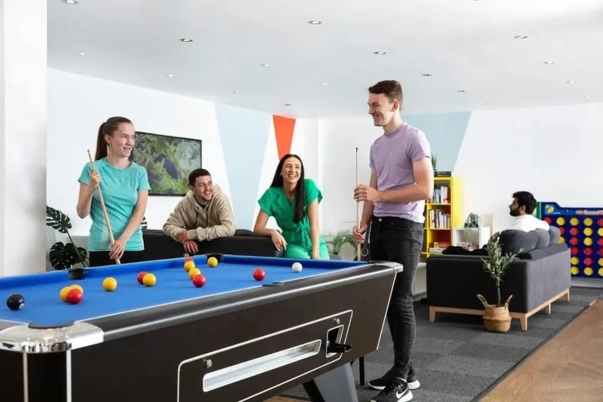 Students playing pool in a common room lounge at Kelvin Court in Glasgow Student Accommodation