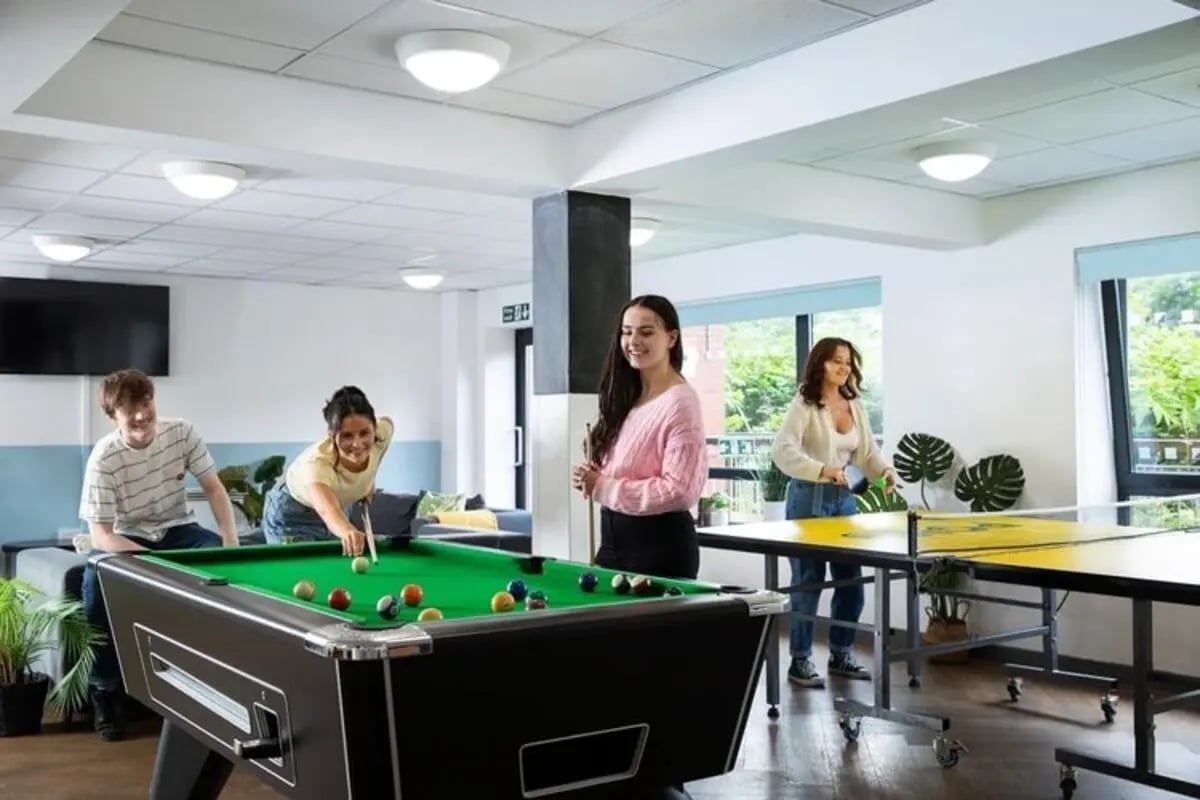 Students play pool and ping pong recreation area at Thurso Street in Glasgow Student Accommodation
