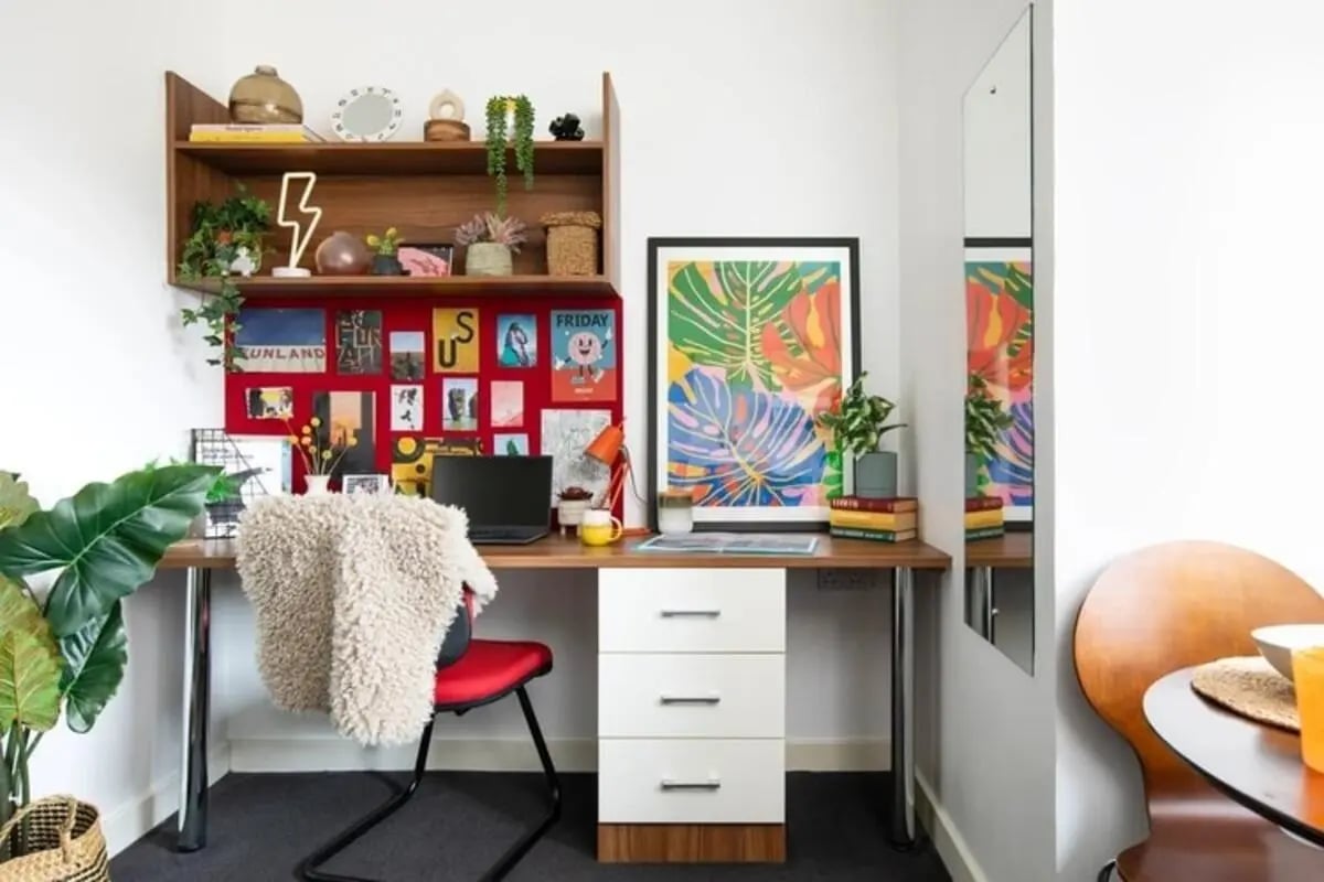 Desk with laptop chair artwork and shelves study area at Kyle Park House in Glasgow Student Accommodation