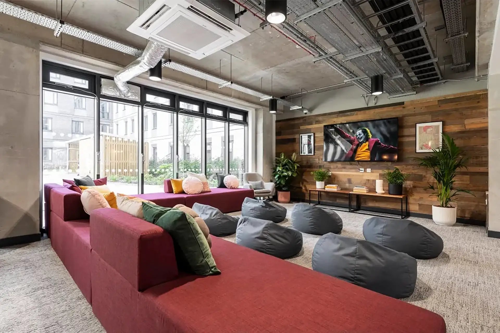 Red sectional couch beanbags and TV lounge area at Riverside  in Canterbury Student Accommodation