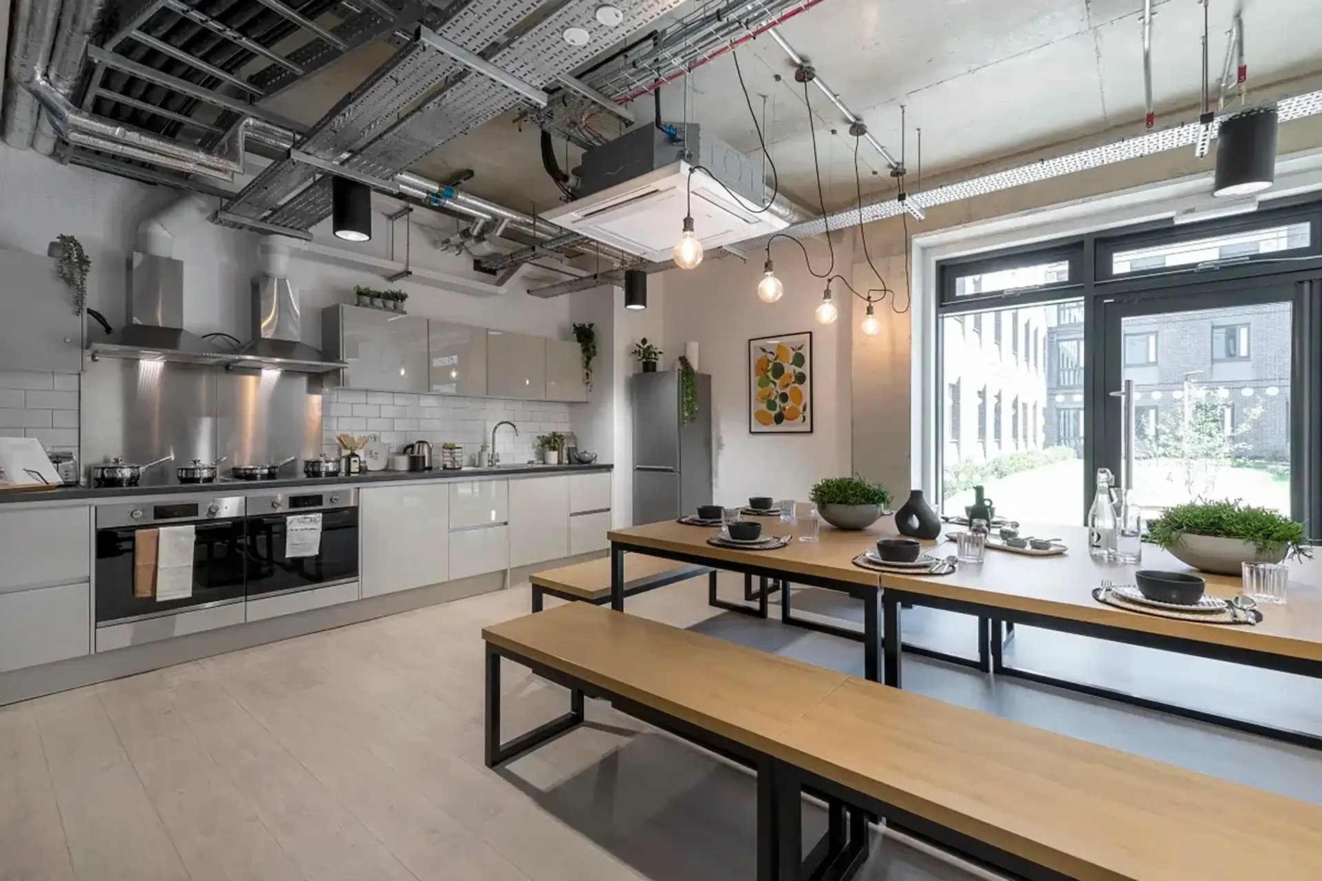 Kitchen counters ovens fridge dining tables benches kitchen at Riverside  in Canterbury Student Accommodation