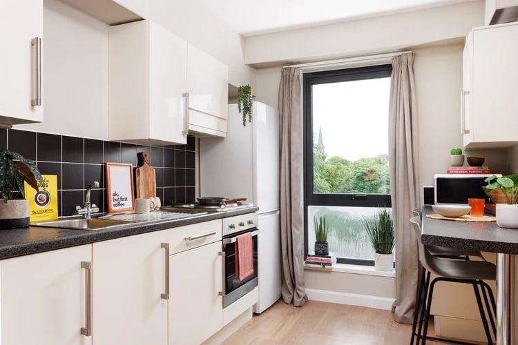 Cream cabinets oven sink and fridge kitchen at Chalmers Street in Edinburgh Student Accommodation