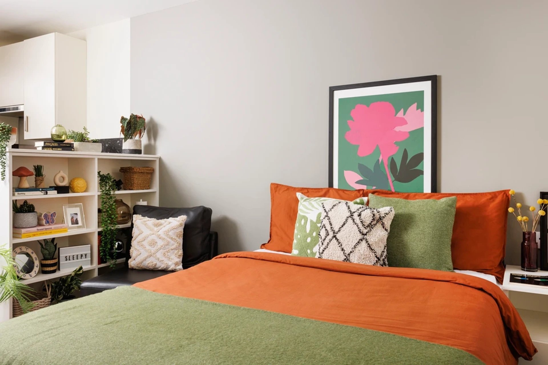 Bed with orange and green bedding and pillows Bedroom at The Old Printworks in Edinburgh Student Accommodation