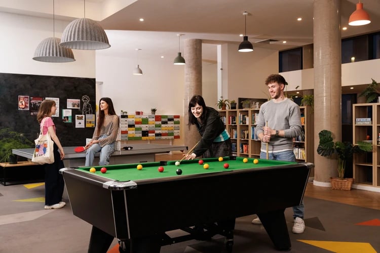 Pool table ping pong table and students playing living room at Salisbury court in Edinburgh Student Accommodation