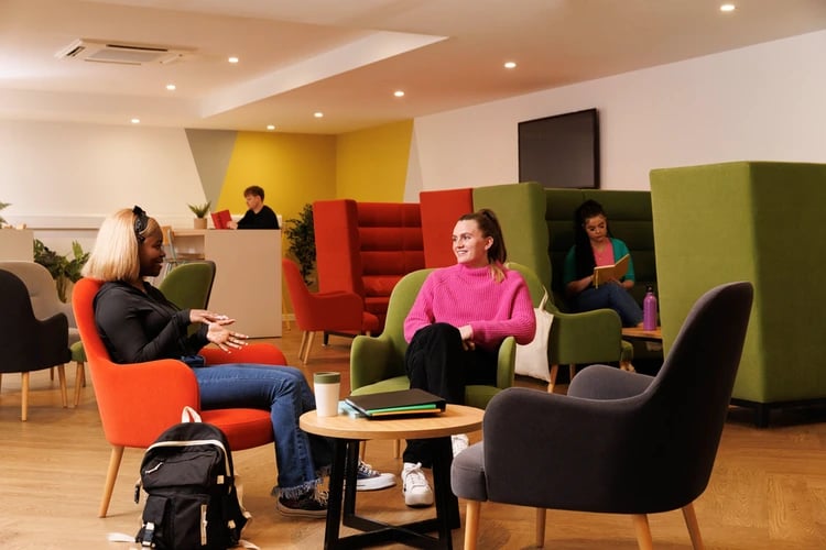Students chatting in colourful seating area common room at Salisbury court in Edinburgh Student Accommodation