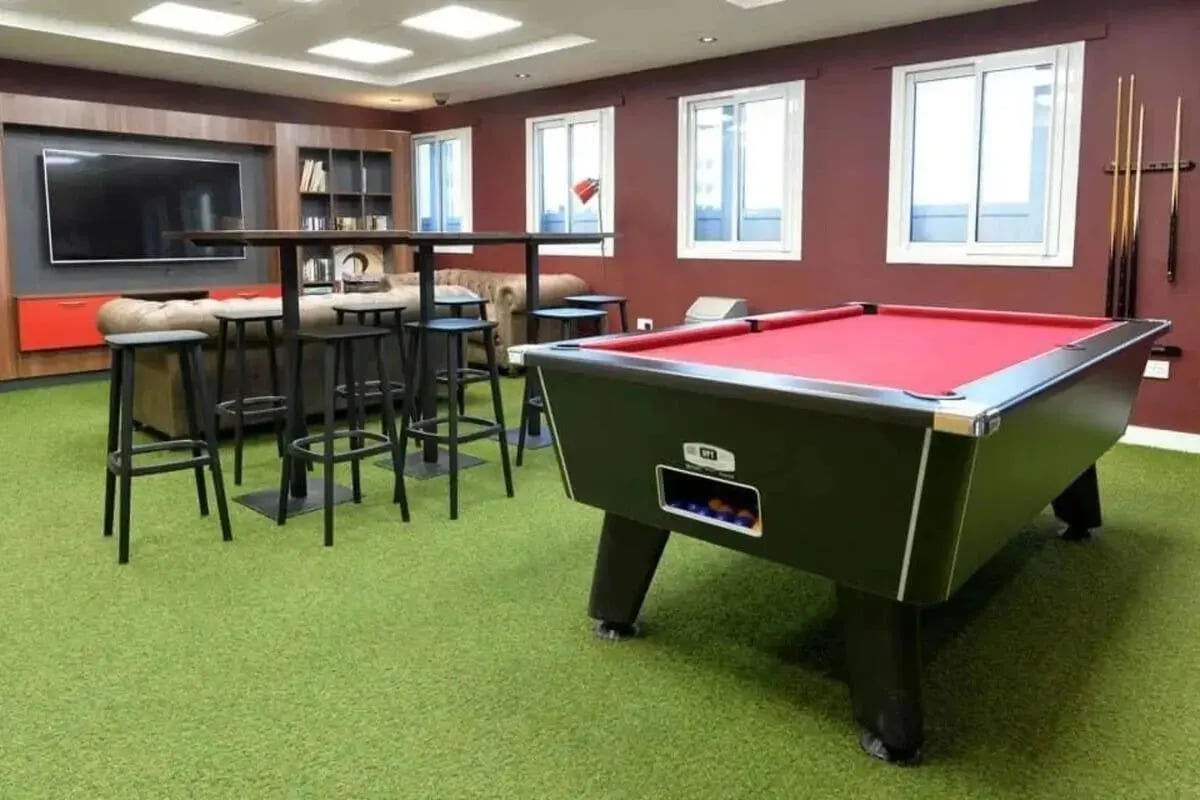 Pool table bar stools sofa television playing area at Wardley House in Bradford Student Accommodation