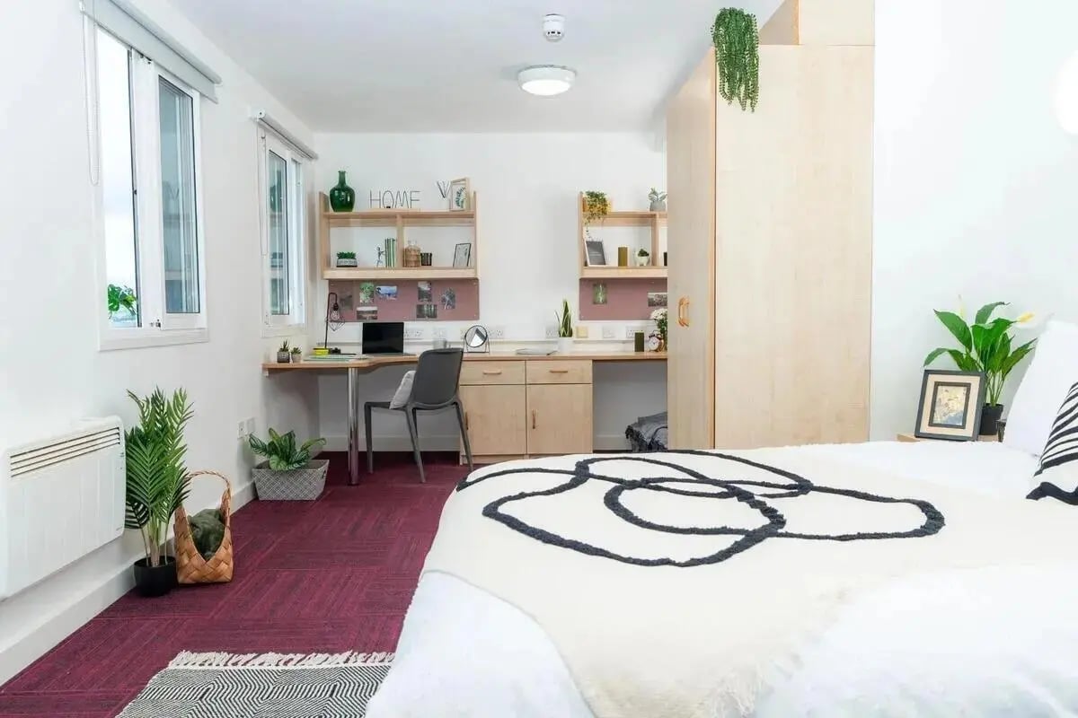 Bed desk plants wardrobe study area bedroom at Wardley House in Bradford Student Accommodation