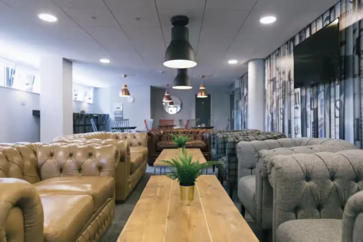 Chesterfield sofas and plant living room at Europa House in Portsmouth Student Accommodation