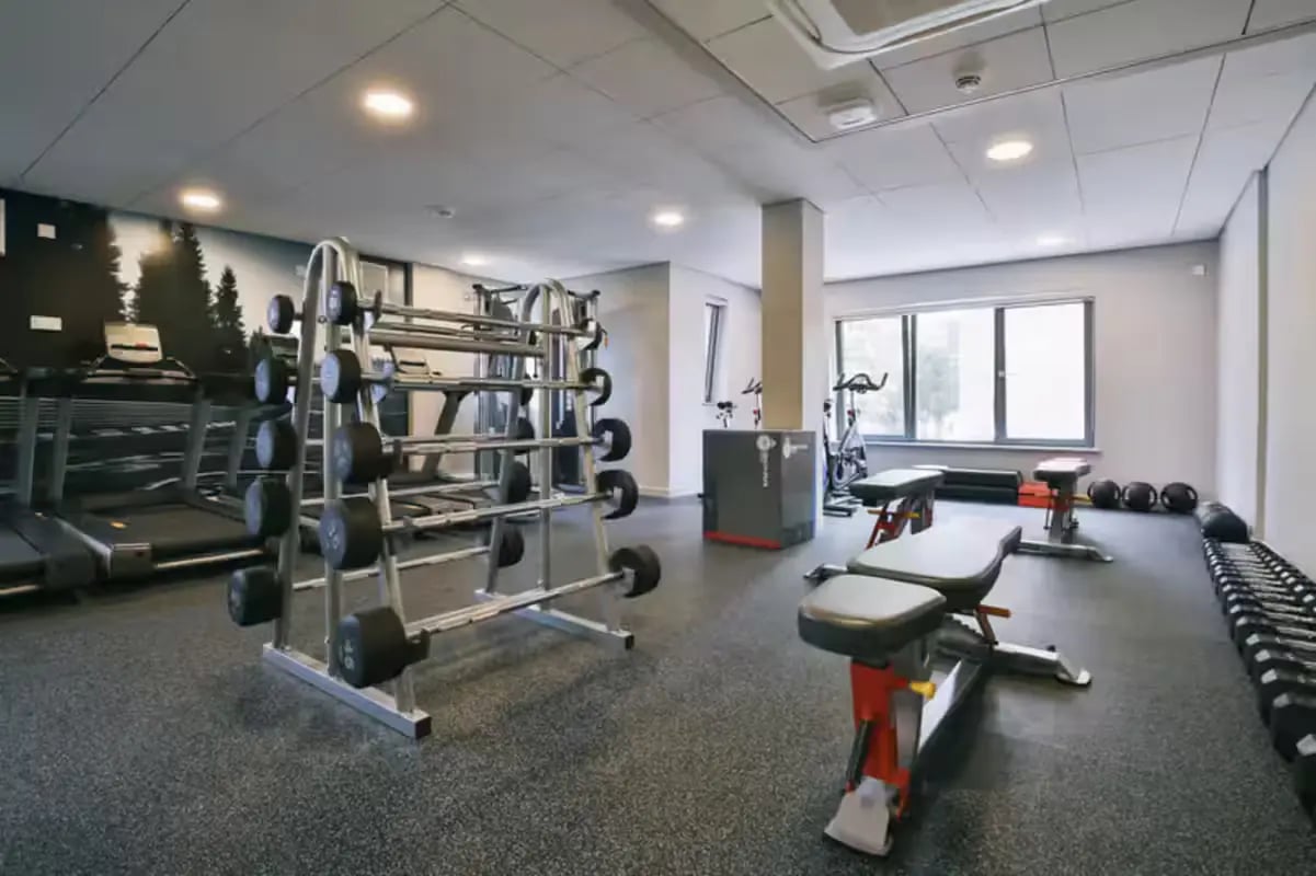Treadmills weight rack exercise benches gym equipment fitness area at Europa House in Portsmouth Student Accommodation