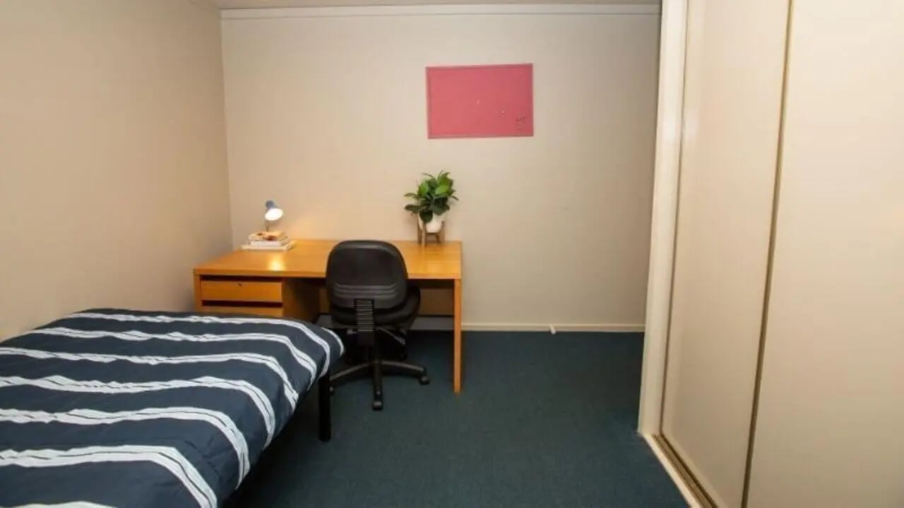 Bed desk chair plant whiteboard bedroom interior at La Trobe University - Villas in Melbourne Student Accommodation