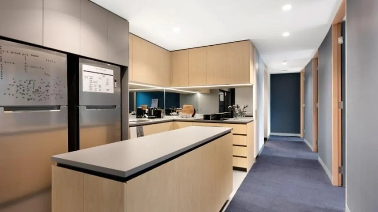Modern kitchen with island stainless steel fridge and cabinets kitchen at La Trobe University - North and South Apartments in Melbourne Student Accommodation