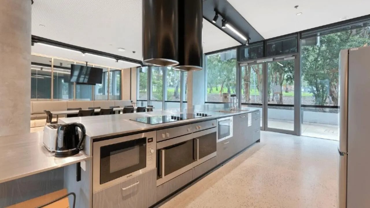 Modern student kitchen with appliances and communal dining area Kitchen at La Trobe University - North and South Apartments in Melbourne Student Accommodation