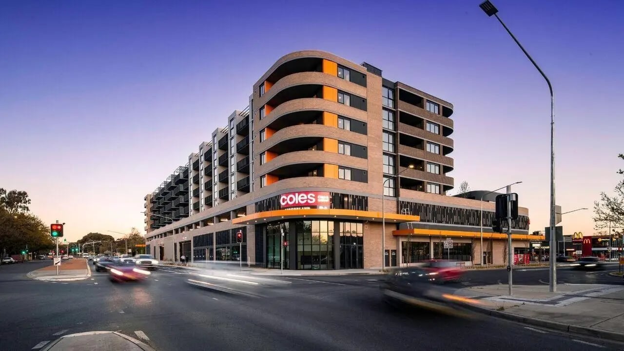 Modern building with balconies and Coles exterior at Dickson Village Apartments in Canberra Student Accommodation