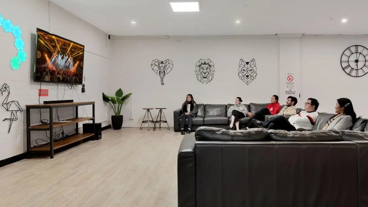 People watching TV on couches living room at La Trobe University - Menzies College in Melbourne Student Accommodation