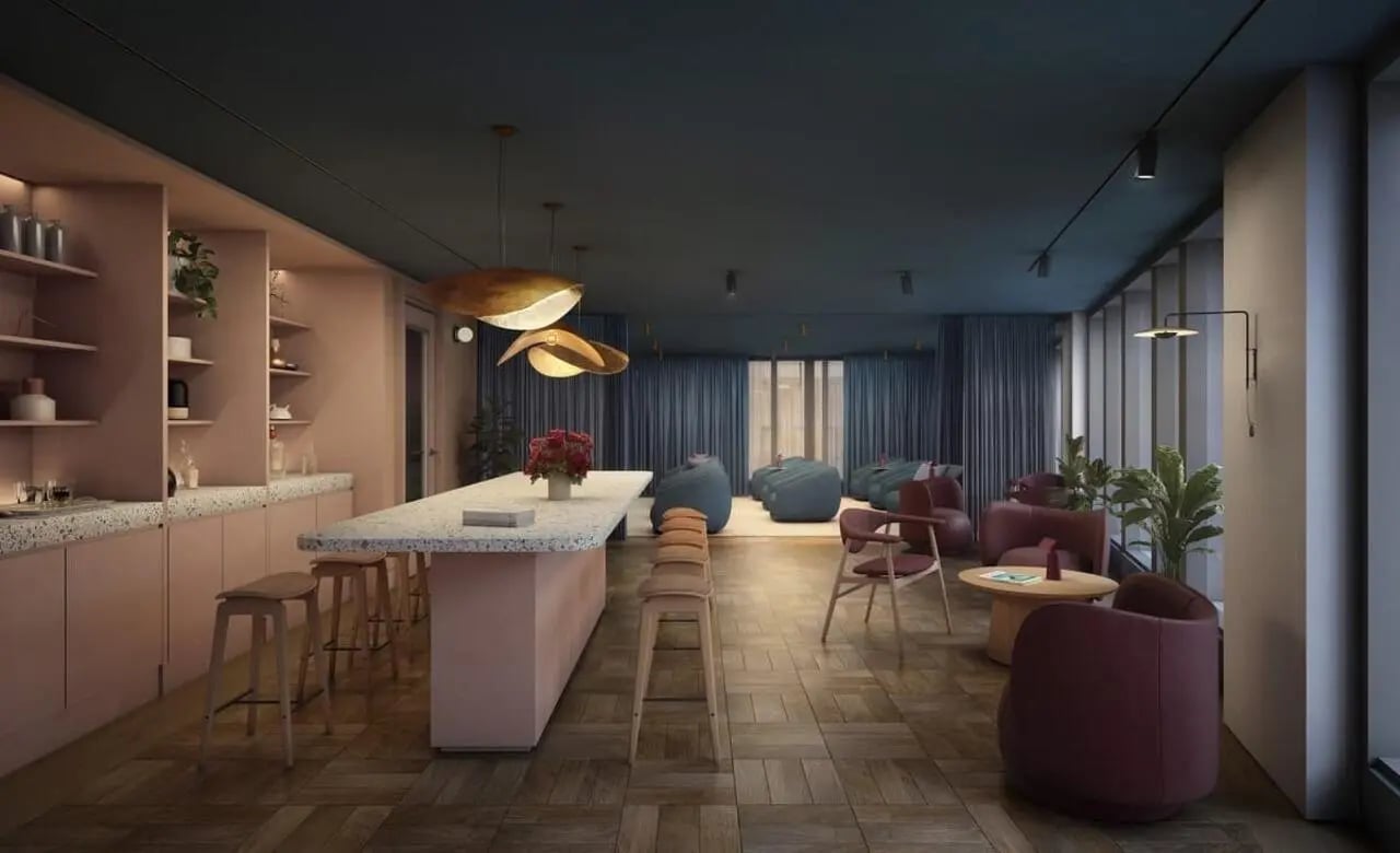 Pink kitchen island with stools and lounge area Living Room at Chapter London Bridge in London Student Accommodation