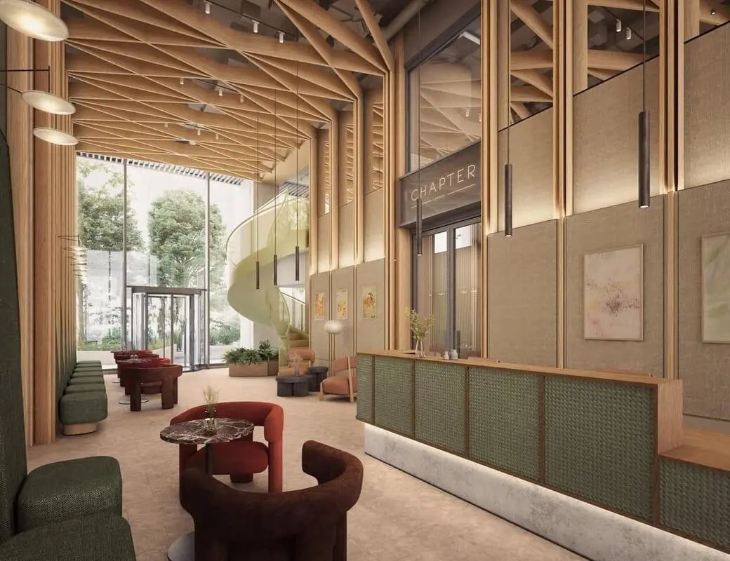 Reception with seating spiral staircase and lobby area at Chapter London Bridge in London Student Accommodation