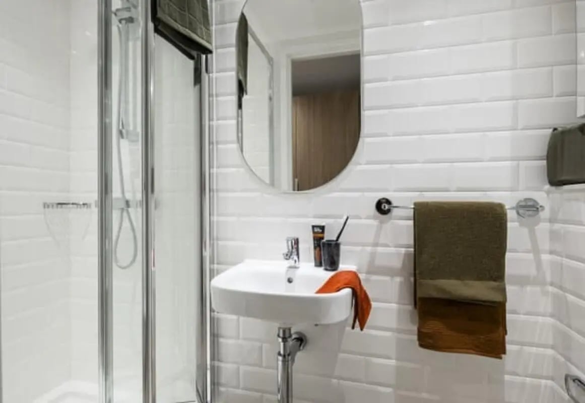 Shower sink mirror and towels bathroom at Wembley Arthur House in Wembley Student Accommodation