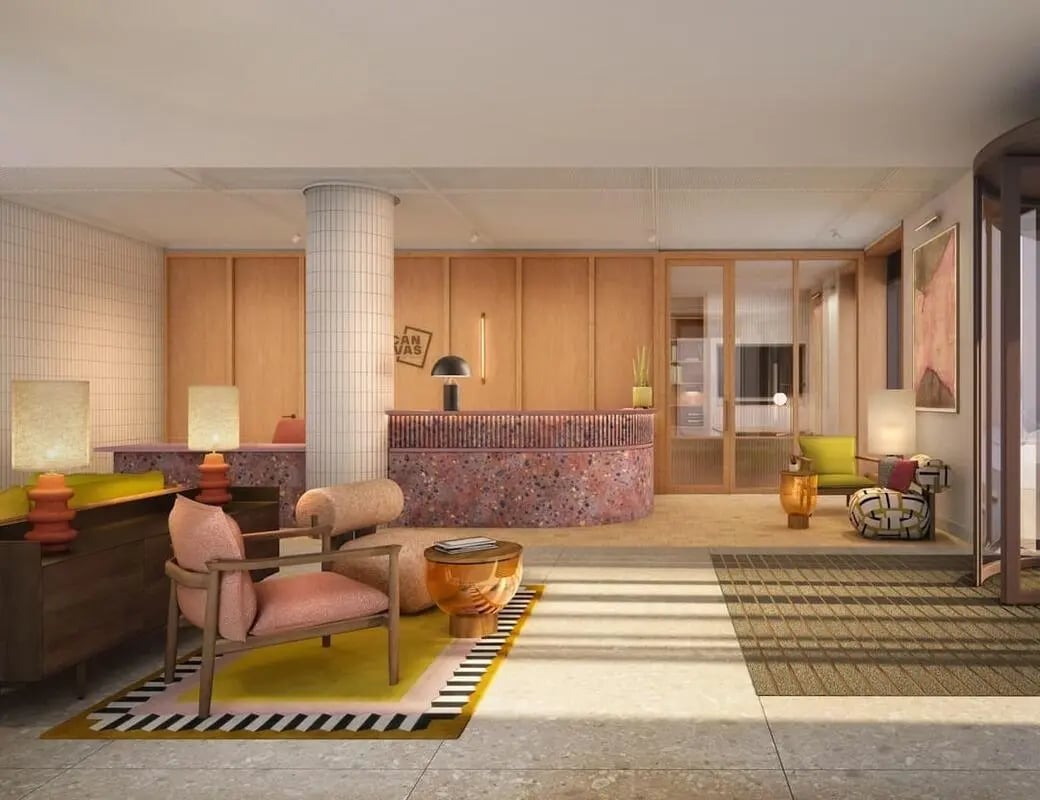 Reception area with terrazzo desk and seating lounge at Wembley Arthur House in Wembley Student Accommodation