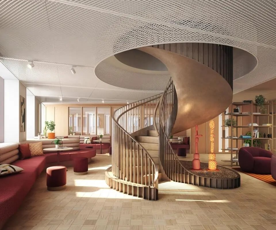 Spiral staircase red sofas wood floor living area at Wembley Arthur House in Wembley Student Accommodation