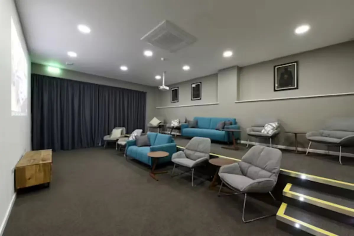 Projector screen couches chairs entertainment room at St Mungo's in Glasgow Student Accommodation