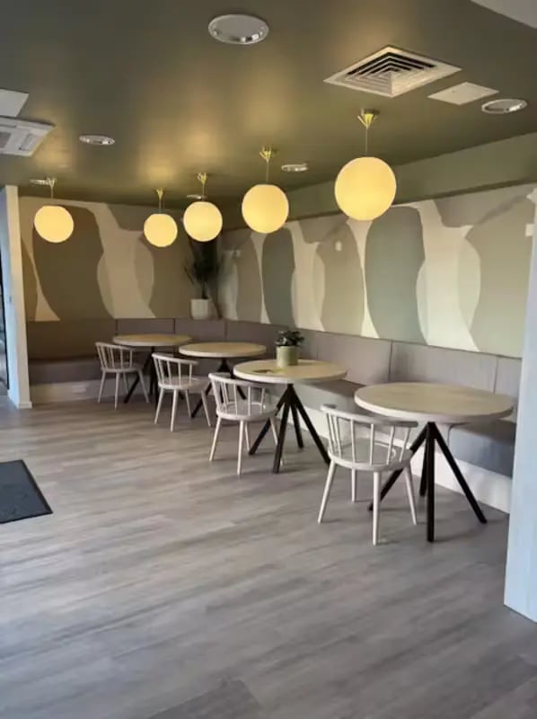 Dining tables and chairs with banquette seating communal area at Dobbie's Point in Glasgow Student Accommodation