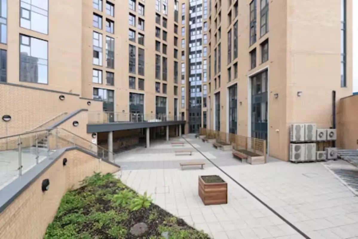 Courtyard with benches planters and modern buildings exterior at Dobbie's Point in Glasgow Student Accommodation