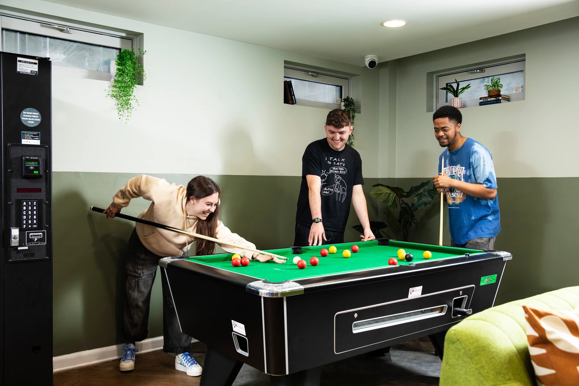 Students playing pool in a recreation room playing area at Beaumont Court in London Student Accommodation