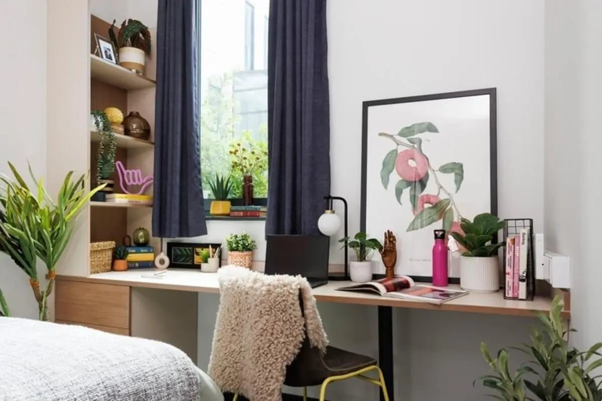 Desk with plants artwork and laptop study area at Wellington St Plaza in Newcastle Upon Tyne Student Accommodation