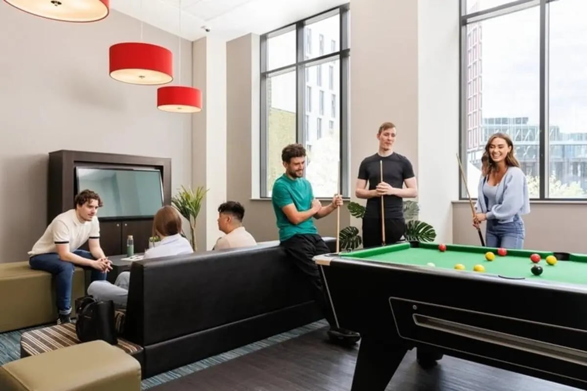 Students playing pool with seating area living room at Wellington St Plaza in Newcastle Upon Tyne Student Accommodation