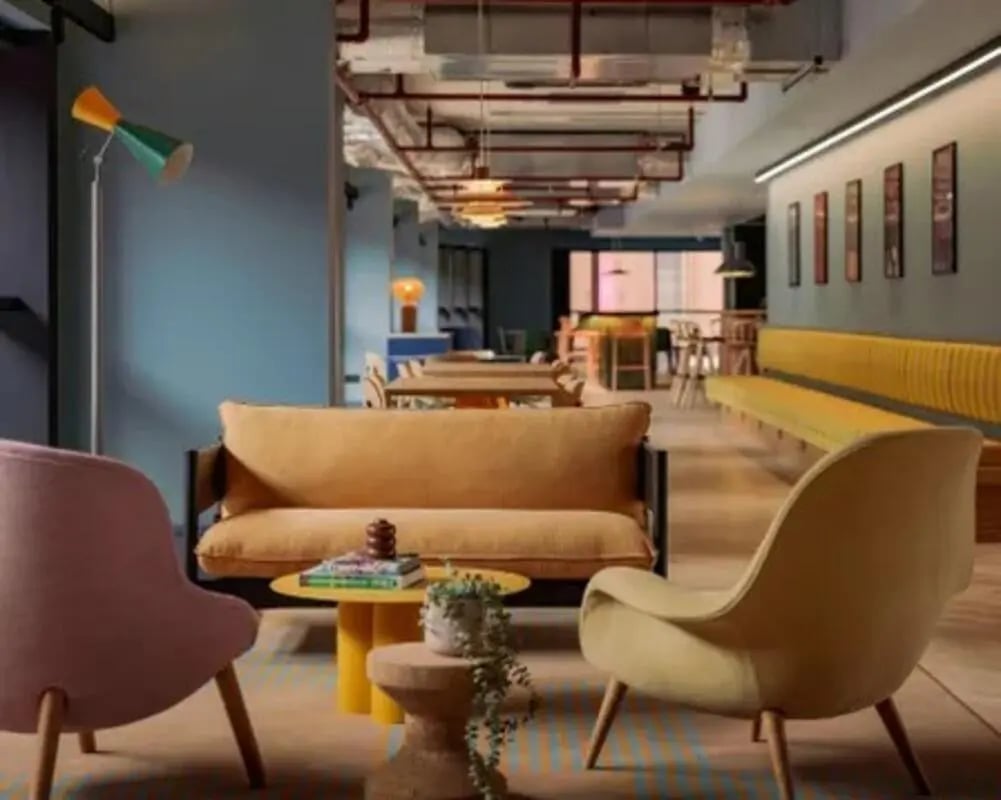 Sofa chairs floor lamp tables and seating living room at Scape Hammersmith in London Student Accommodation