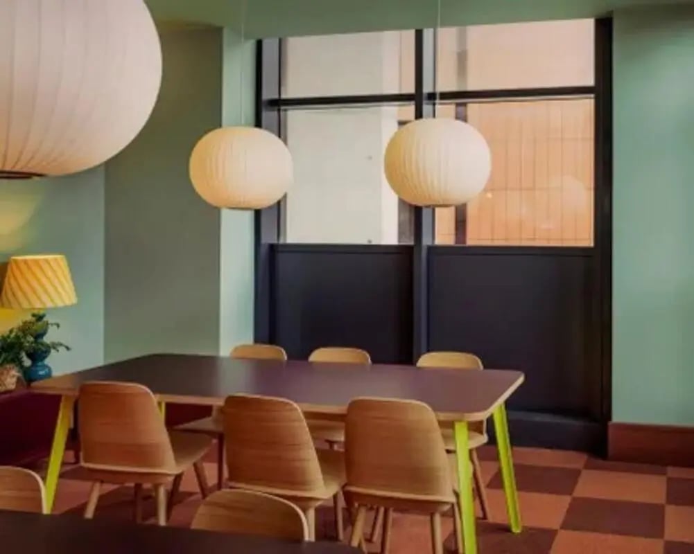 Dining table with chairs and pendant lights dining area at Scape Hammersmith in London Student Accommodation