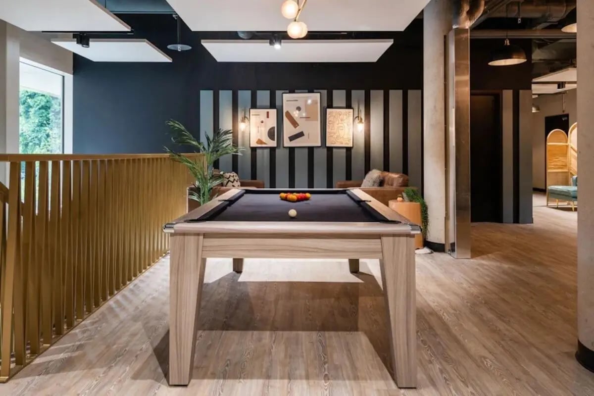 Pool table with balls and wooden railing playing area at Hillfort House in Brighton Student Accommodation