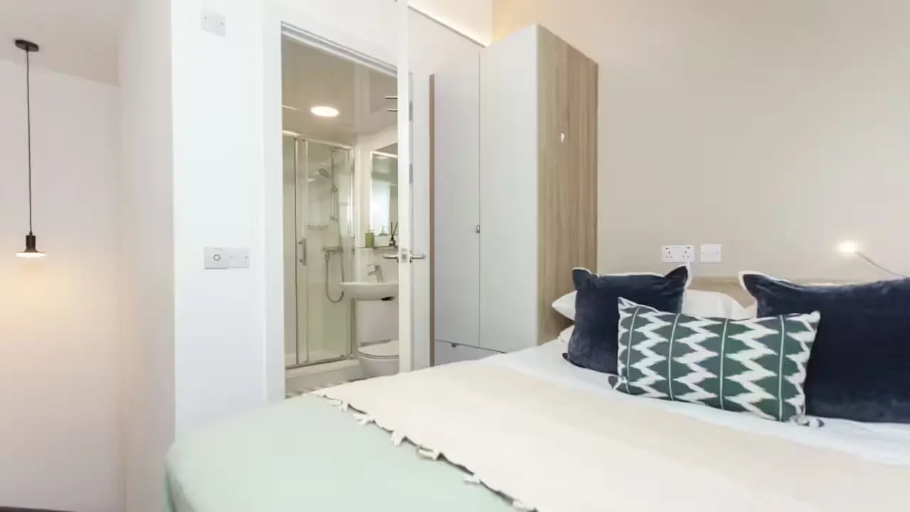 Bed with pillows wardrobe visible bathroom bedroom at Gillows in Lancaster Student Accommodation