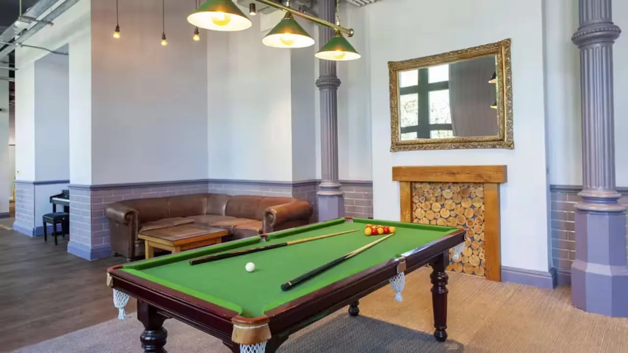 Pool table sofa piano fireplace lounge area at Gillows in Lancaster Student Accommodation
