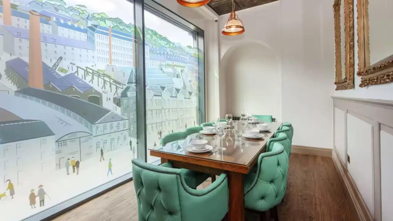 Dining table with upholstered chairs living room at Gillows in Lancaster Student Accommodation