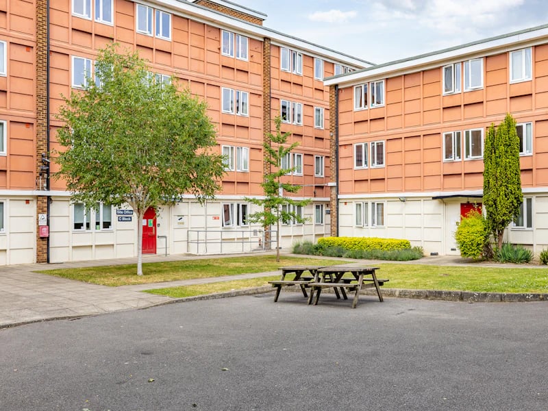 Picnic tables and student accommodation exterior at Brooke Hall in London Student Accommodation
