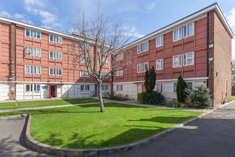 Brick and red building with green lawn exterior at Brooke Hall in London Student Accommodation