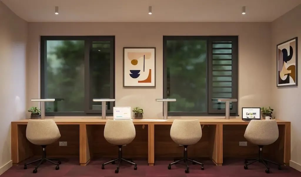 Four study desks with chairs laptops artwork study area at Ironworks House in London Student Accommodation