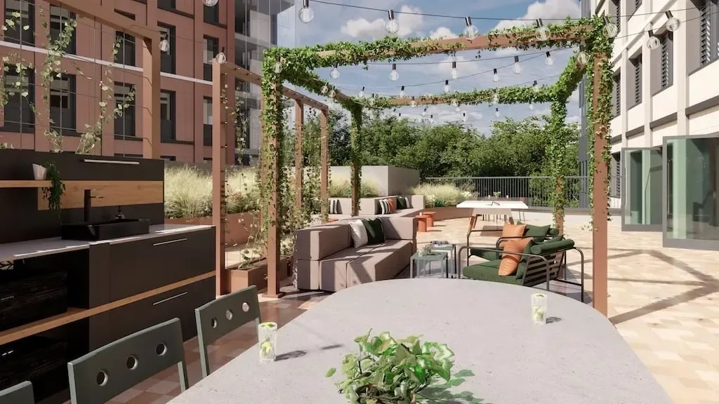 Outdoor kitchen lounge area with seating and tables Outdoor Area at Ironworks House in London Student Accommodation