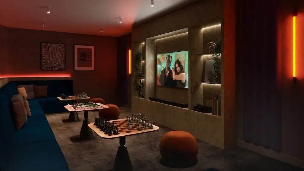 Blue sofa chess tables and television lounge area at Ironworks House in London Student Accommodation