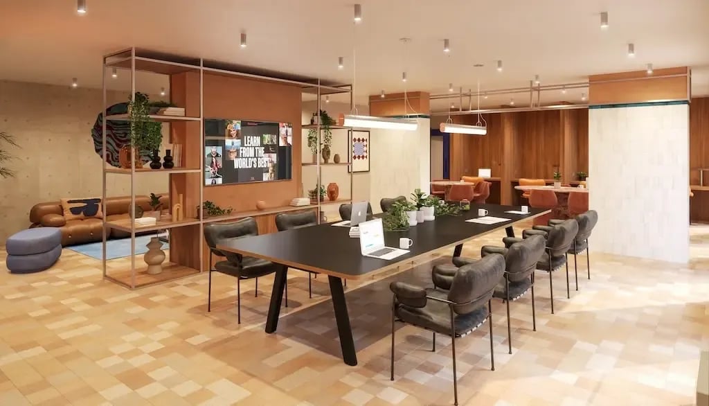 Long table with chairs and couches communal area at Ironworks House in London Student Accommodation