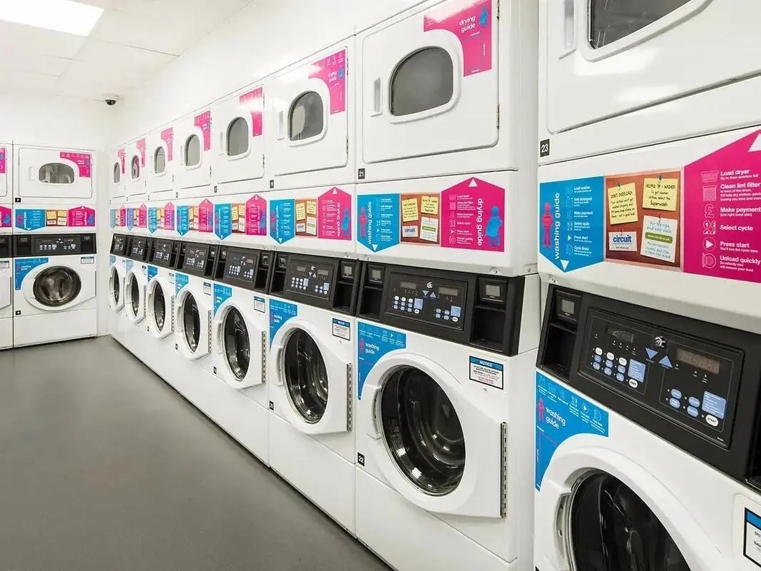 Washing machines and dryers stacked high laundry room at Yugo Catherine House in Portsmouth Student Accommodation