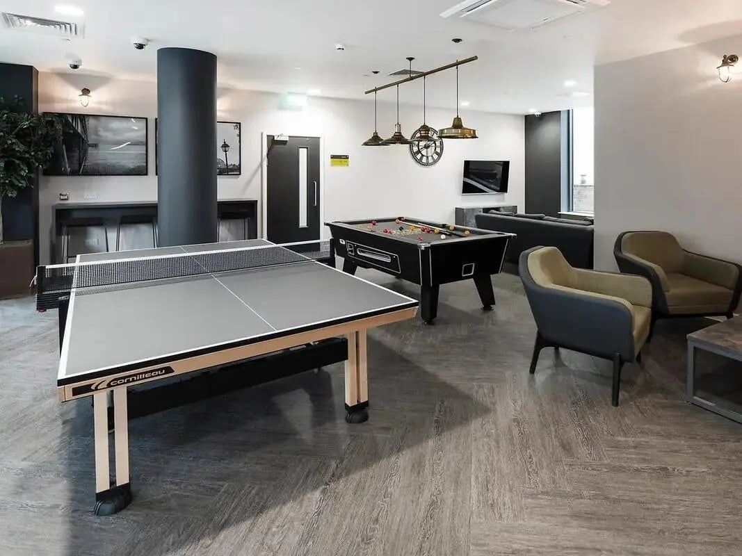 Ping pong table pool table lounge chairs living room at Yugo Catherine House in Portsmouth Student Accommodation