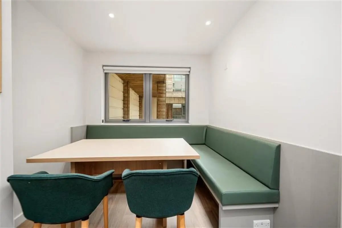 Green booth seating with table and chairs dining area at Cathedral Park in Bristol Student Accommodation
