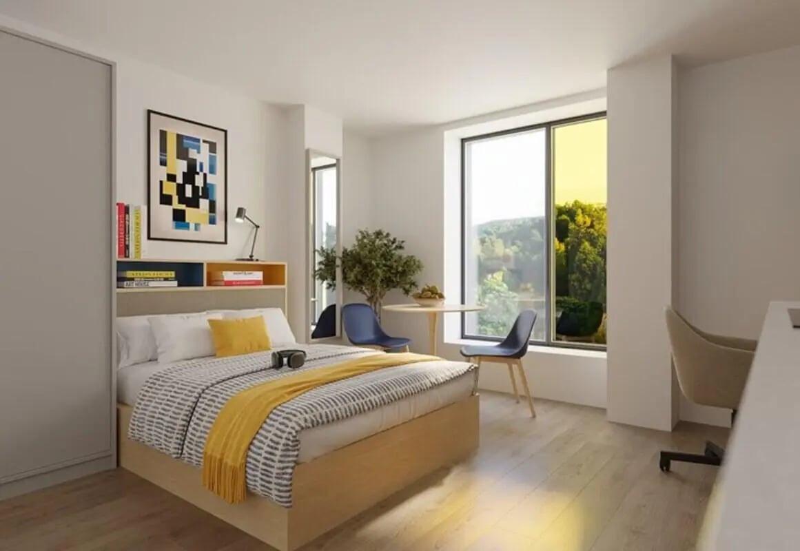 Bed table chairs and desk bedroom interior at Brigg Point in Bristol Student Accommodation