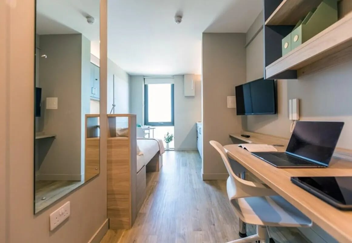 Bed desk and TV in studio apartment living room at Brigg Point in Bristol Student Accommodation