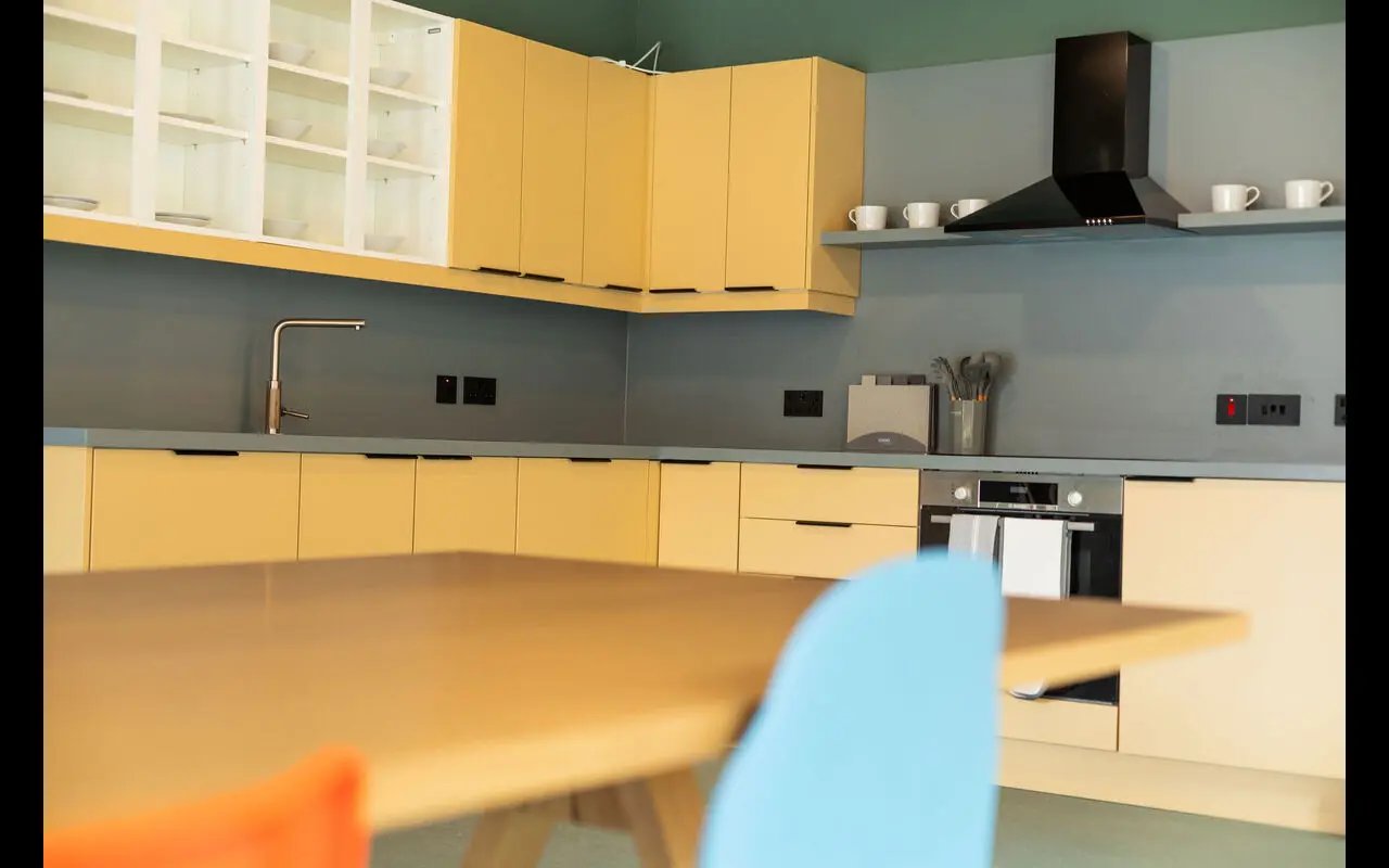 Modern yellow cabinets with sink and oven Kitchen at Martha Street Apartments in Glasgow Student Accommodation