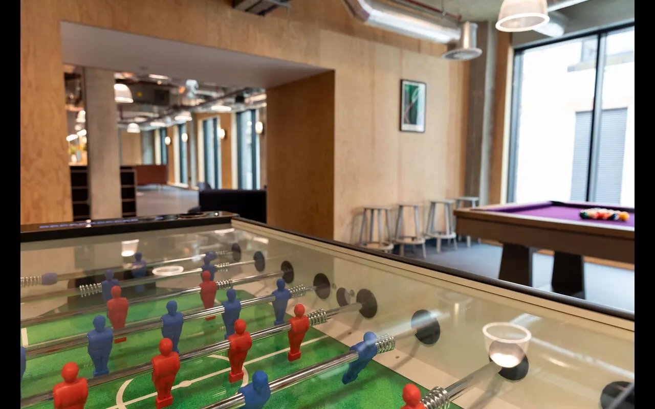 Foosball table purple pool table stools communal room exterior at Martha Street Apartments in Glasgow Student Accommodation
