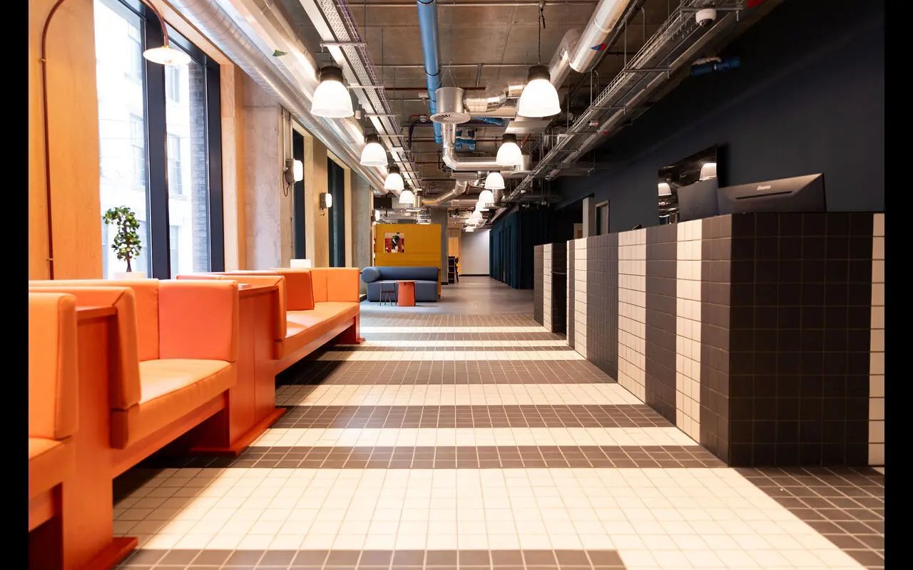 Orange bench seating tiled reception desk communal area at Martha Street Apartments in Glasgow Student Accommodation