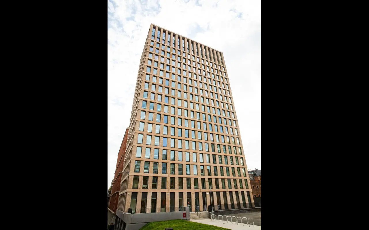 Modern brick high rise building with many windows exterior at Martha Street Apartments in Glasgow Student Accommodation